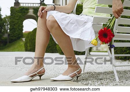 Low section view of a woman holding a bouquet of flowers View Large Photo Image Stock Image - Low section view of a woman holding a bouquet of flowers . Fotosearch