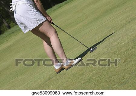 Stock Image - Low section view of a woman playing golf. Fotosearch