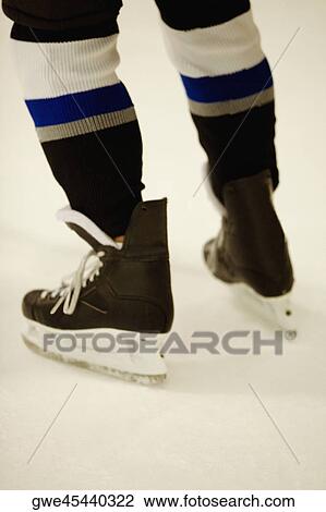 Low section view of an ice hockey player wearing ice skates View Large Photo Image Stock Image - Low section view of an ice hockey player wearing ice skates. Fotosearch