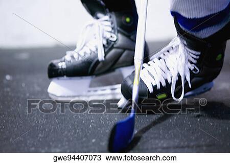 Low section view of an ice hockey player playing ice hockey View Large Photo Image Stock Image - Low section view of an ice hockey player playing ice hockey. Fotosearch