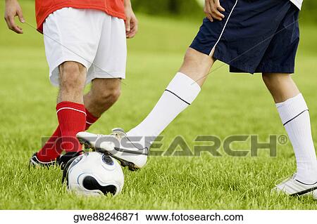 Low section view of two soccer players playing soccer View Large Photo Image Stock Image - Low section view of two soccer players playing soccer. Fotosearch