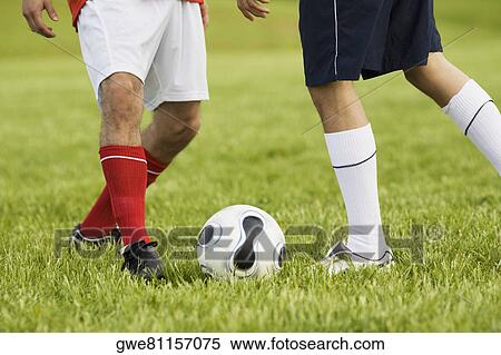 Low section view of two soccer players playing soccer View Large Photo Image Stock Photography - Low section view of two soccer players playing soccer. Fotosearch
