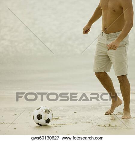 Man playing with a soccer ball on the beach View Large Photo Image Stock Photo - Man playing with a soccer ball on the beach. Fotosearch