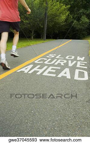 Stock Image - Man running on a road. Fotosearch