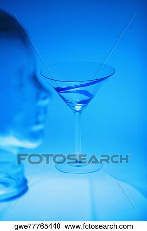 Stock Image - Martini glass near a glass mannequin. Fotosearch