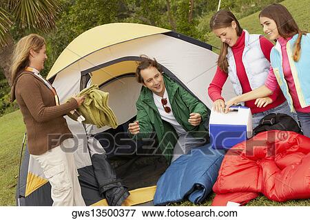 Mature man and a mid adult woman camping with their two daughters View Large Photo Image Stock Photo - Mature man and a mid adult woman camping with their two daughters. Fotosearch