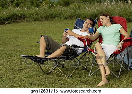 Mid adult couple holding tea cups View Large Photo Image Stock Photography - Mid adult couple holding tea cups. Fotosearch