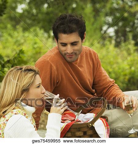 Mid adult man and a young woman drinking champagne View Large Photo Image Stock Photography - Mid adult man and a young woman drinking champagne. Fotosearch