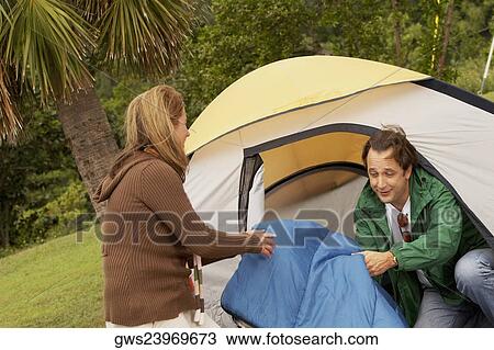 Mid adult woman and a mature man camping View Large Photo Image Stock Image - Mid adult woman and a mature man camping. Fotosearch