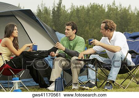 Mid adult woman and two mid adult men talking to each other View Large Photo Image Stock Image - Mid adult woman and two mid adult men talking to each other. Fotosearch