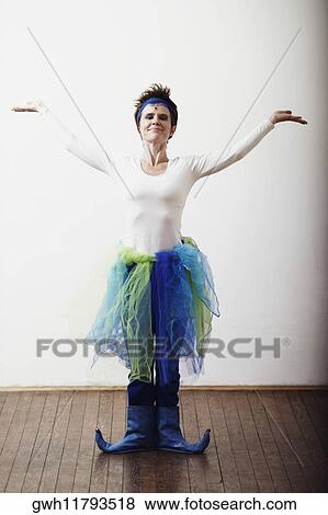 Mid adult woman dancing with her arms raised View Large Photo Image Stock Photo - Mid adult woman dancing with her arms raised. Fotosearch