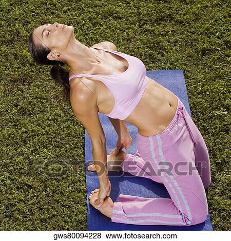 Mid adult woman in a yoga position View Large Photo Image Stock Photo - Mid adult woman in a yoga position. Fotosearch