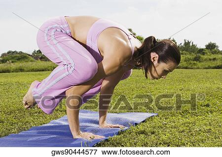 Mid adult woman in a yoga position View Large Photo Image Stock Photo - Mid adult woman in a yoga position. Fotosearch