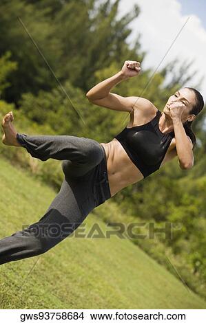 Mid adult woman practicing martial arts View Large Photo Image Picture - Mid adult woman practicing martial arts. Fotosearch