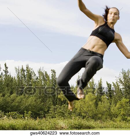 Stock Image - Mid adult woman practicing martial arts. Fotosearch