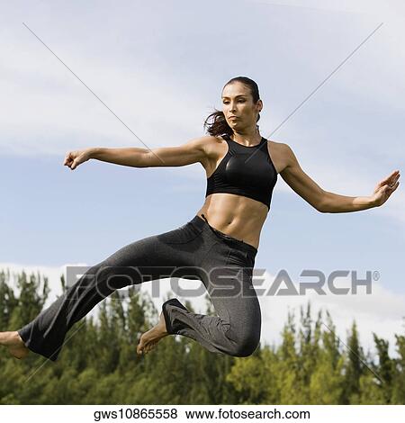 Mid adult woman practicing martial arts View Large Photo Image Stock Photo - Mid adult woman practicing martial arts. Fotosearch