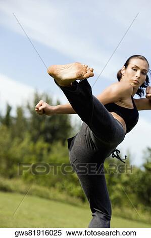 Mid adult woman practicing martial arts View Large Photo Image Stock Photography - Mid adult woman practicing martial arts. Fotosearch