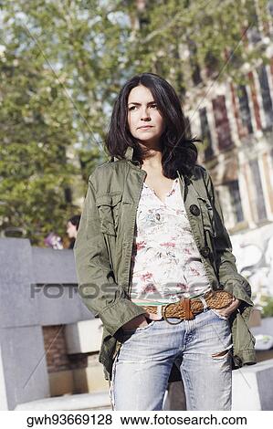 Mid adult woman standing with her hands in her pockets View Large Photo Image Stock Photo - Mid adult woman standing with her hands in her pockets . Fotosearch