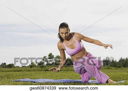 Mid adult woman stretching on an exercise mat View Large Photo Image Stock Photo - Mid adult woman stretching on an exercise mat. Fotosearch