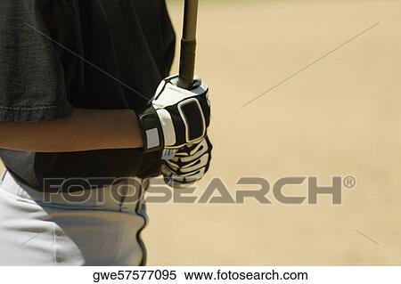 Mid section view of a boy holding a baseball bat View Large Photo Image Stock Photography - Mid section view of a boy holding a baseball bat. Fotosearch