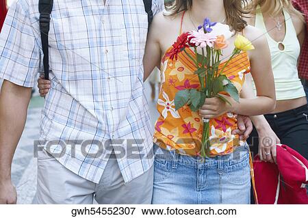 Mid section view of a couple walking View Large Photo Image Stock Photo - Mid section view of a couple walking . Fotosearch