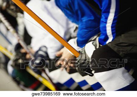Mid section view of a group of ice hockey players holding ice hockey sticks View Large Photo Image Stock Photo - Mid section view of a group of ice hockey players holding ice hockey sticks. Fotosearch