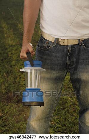 Mid section view of a man holding a fluorescent light View Large Photo Image Stock Photo - Mid section view of a man holding a fluorescent light. Fotosearch
