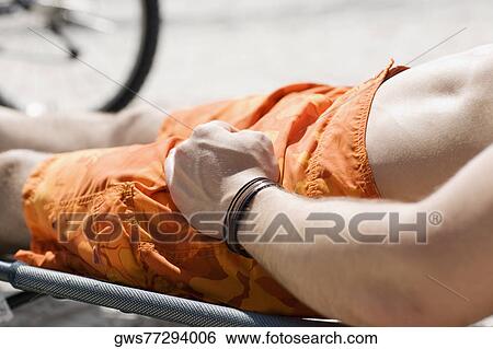 Mid section view of a man reclining on a lounge chair on the beach View Large Photo Image Stock Photograph - Mid section view of a man reclining on a lounge chair on the beach. Fotosearch