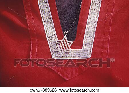 Stock Photograph - Mid section view of a man wearing a star shaped pendant. Fotosearch