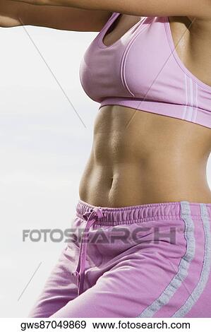 Stock Photo - Mid section view of a mid adult woman exercising. Fotosearch