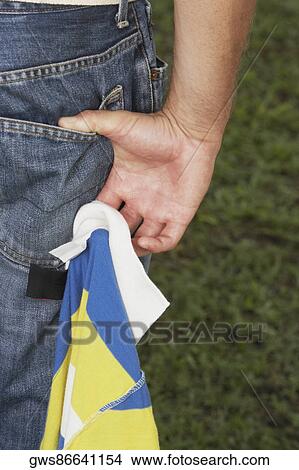 Mid section view of a person holding a polo shirt View Large Photo Image Picture - Mid section view of a person holding a polo shirt. Fotosearch