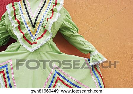 Stock Photo - Mid section view of a woman holding her dress. Fotosearch