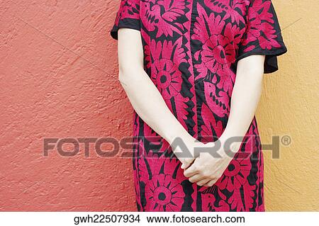 Mid section view of a woman standing View Large Photo Image Picture - Mid section view of a woman standing. Fotosearch