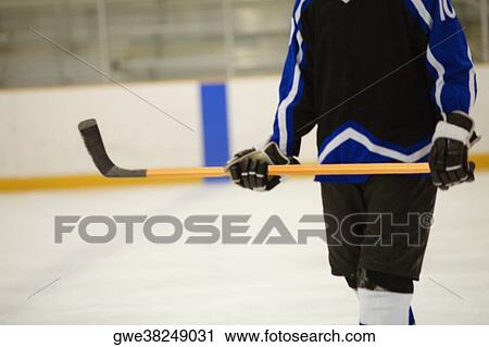 Stock Image - Mid section view of an ice hockey player. Fotosearch