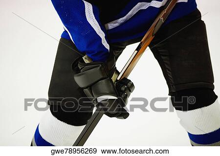 Mid section view of an ice hockey player playing ice hockey View Large Photo Image Stock Photo - Mid section view of an ice hockey player playing ice hockey. Fotosearch