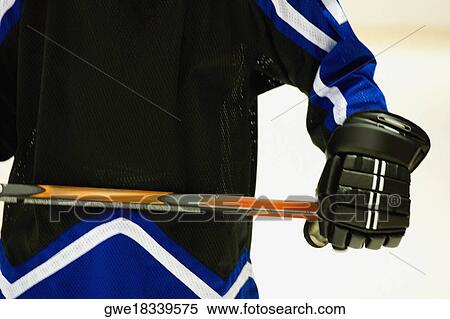 Mid section view of an ice hockey player holding an ice hockey stick View Large Photo Image Stock Photography - Mid section view of an ice hockey player holding an ice hockey stick. Fotosearch