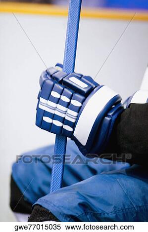 Mid section view of an ice hockey player holding an ice hockey stick View Large Photo Image Stock Photography - Mid section view of an ice hockey player holding an ice hockey stick. Fotosearch