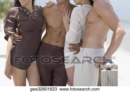 Mid section view of two young couples standing on a pier View Large Photo Image Stock Image - Mid section view of two young couples standing on a pier. Fotosearch