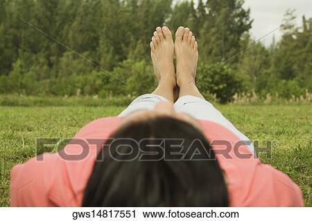 Person lying on the grass View Large Photo Image Stock Image - Person lying on the grass. Fotosearch