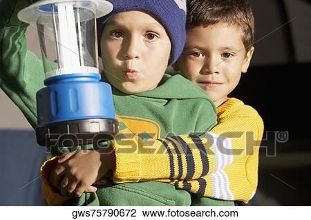 Portrait a boy hugging his friend and holding a lantern View Large Photo Image Stock Image - Portrait a boy hugging his friend and holding a lantern. Fotosearch