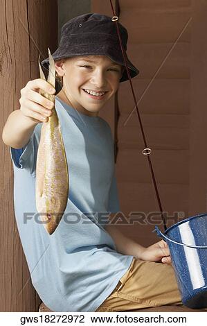 Portrait of a boy holding a trout and smiling View Large Photo Image Stock Image - Portrait of a boy holding a trout and smiling. Fotosearch
