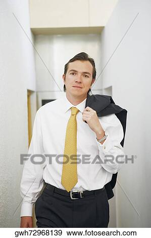 Portrait of a businessman carrying his coat over his shoulder View Large Photo Image Stock Photo - Portrait of a businessman carrying his coat over his shoulder. Fotosearch