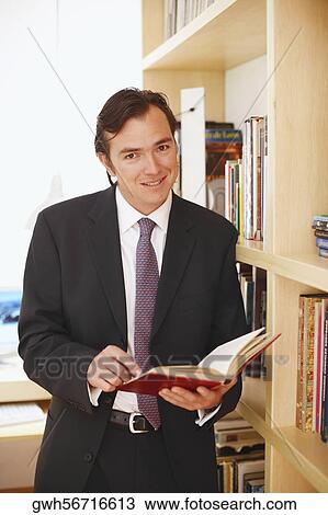 Portrait of a businessman holding a diary View Large Photo Image Stock Image - Portrait of a businessman holding a diary. Fotosearch