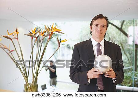 Portrait of a businessman holding a crystal ball View Large Photo Image Stock Photograph - Portrait of a businessman holding a crystal ball. Fotosearch