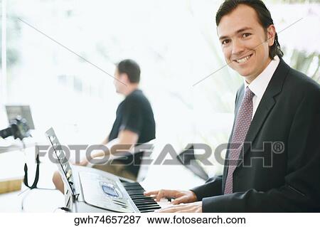 Portrait of a businessman playing the piano View Large Photo Image Stock Photo - Portrait of a businessman playing the piano. Fotosearch