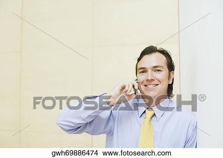 Portrait of a businessman talking on a mobile phone View Large Photo Image Picture - Portrait of a businessman talking on a mobile phone. Fotosearch