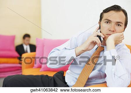 Stock Image - Portrait of a businessman talking on a mobile phone. Fotosearch
