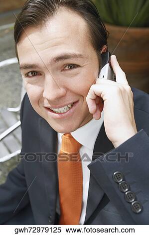 Stock Photography - Portrait of a businessman talking on a mobile phone. Fotosearch