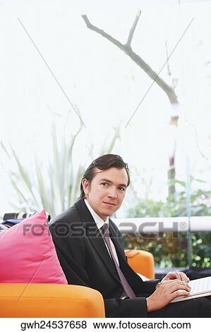 Portrait of a businessman using a laptop View Large Photo Image Stock Photo - Portrait of a businessman using a laptop. Fotosearch