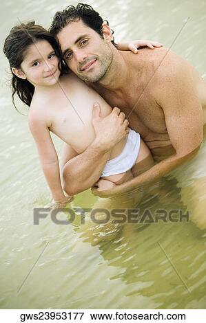 Stock Photo - Portrait of a father hugging his daughter. Fotosearch